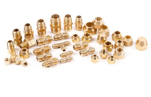 Wide assortment of brass fittings and connectors including nuts, couplings, and adapters