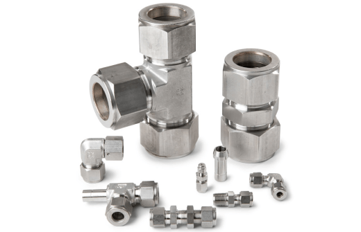 Assortment of stainless steel compression fittings and connectors on a white background