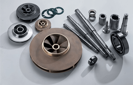 Precision-engineered industrial components including shafts, impellers, and bearings arranged on a surface.