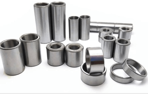 Assorted stainless steel cylindrical components and sleeves for industrial applications.